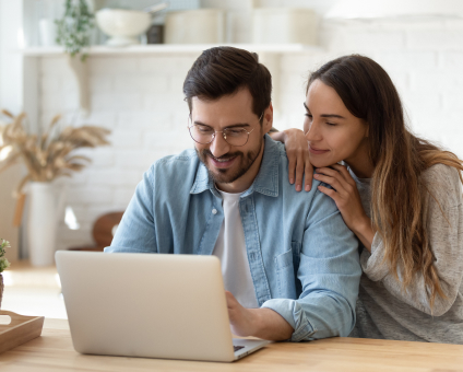 Couple requesting a cleaning quote on a laptop